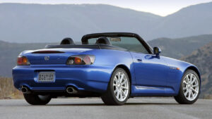 Blue sports car parked on a scenic road