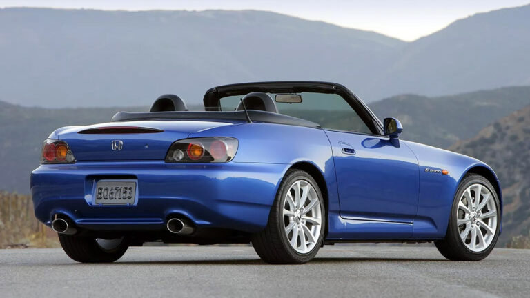 Blue sports car parked on a scenic road