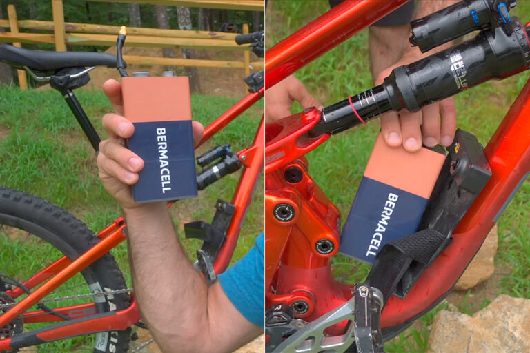 Person holding two red electronic devices with wires outdoors