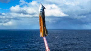 Rocket ascending into the sky over the ocean