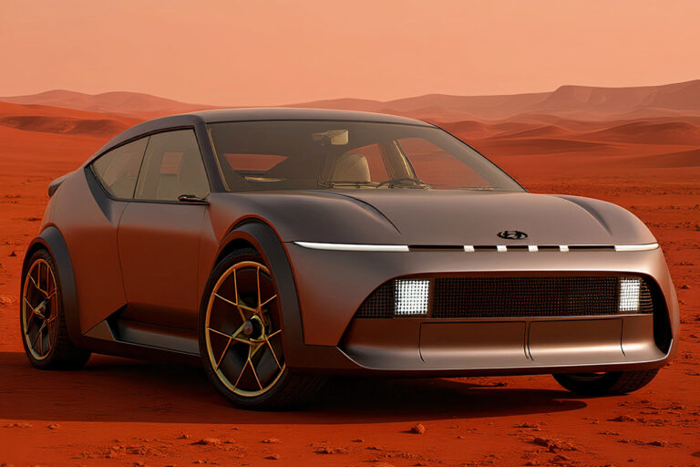 Hand holding car keys near a parked luxury car in Dubai